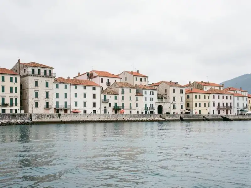Stone buildings with terracotta roofs along the Adriatic waterfront in Croatia